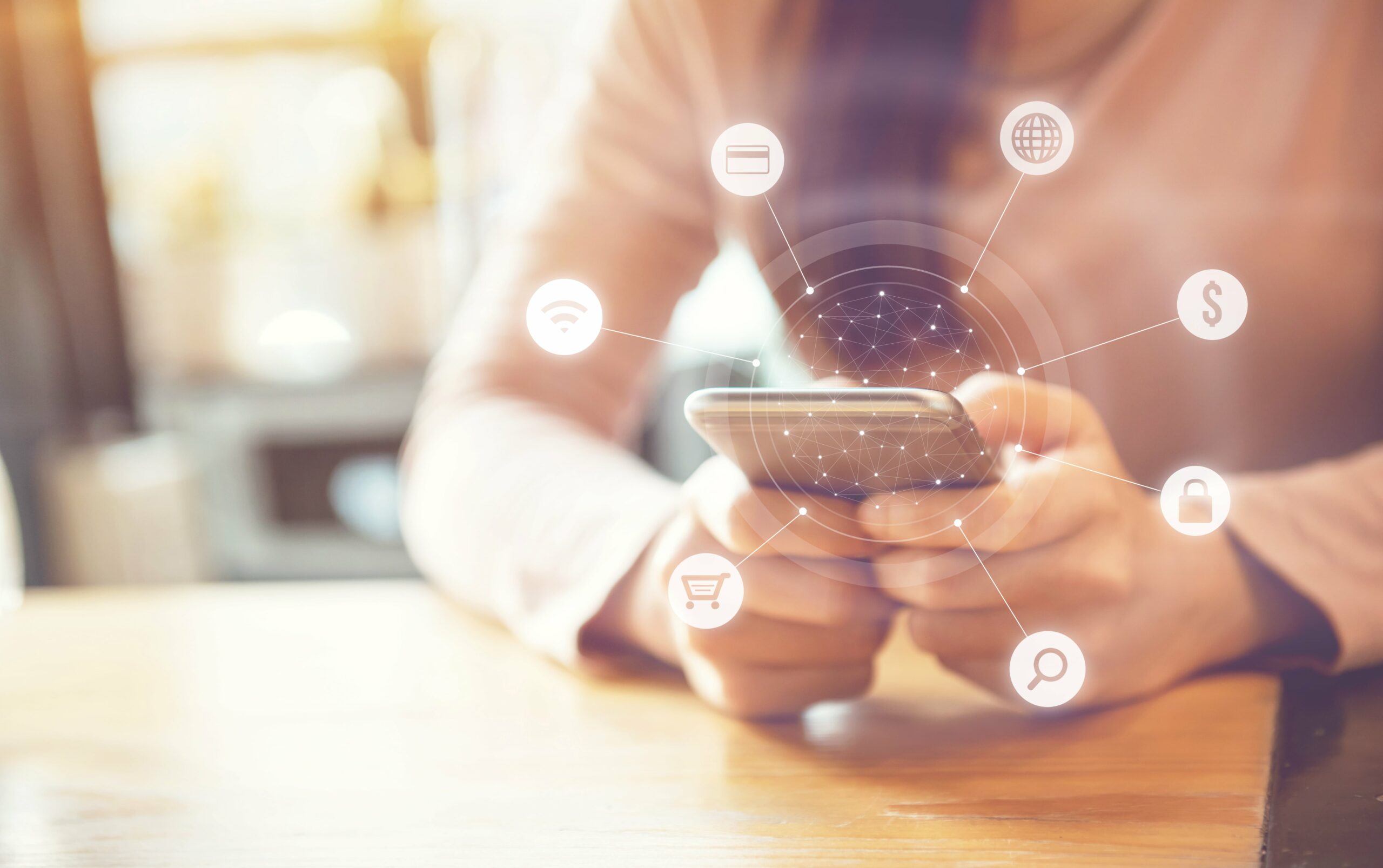an image of someone holding a phone with various symbols floating around it to convey what is advertising in present day